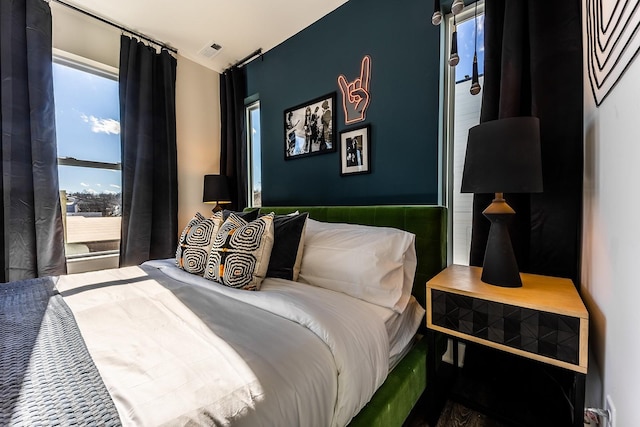 bedroom featuring visible vents and multiple windows