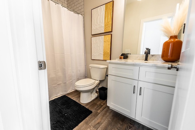 full bathroom with a shower with shower curtain, vanity, toilet, and wood finished floors