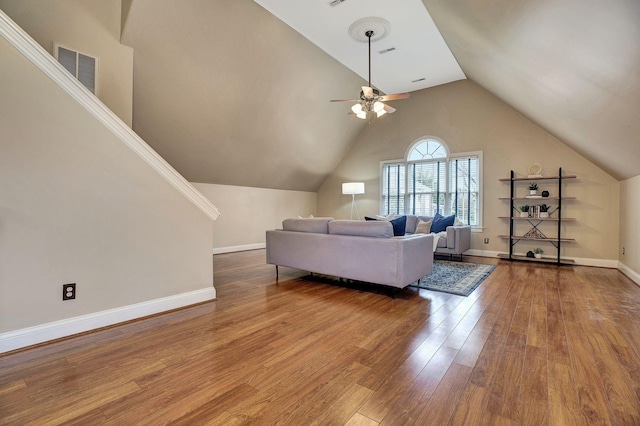 living room featuring baseboards, visible vents, ceiling fan, wood finished floors, and high vaulted ceiling