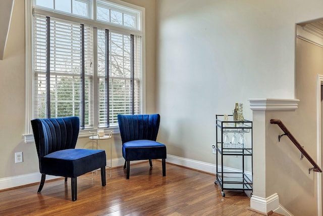 living area with baseboards and wood finished floors