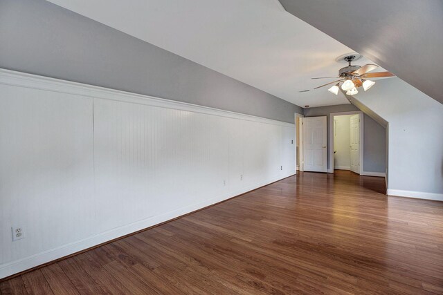 additional living space with ceiling fan, wood finished floors, and baseboards