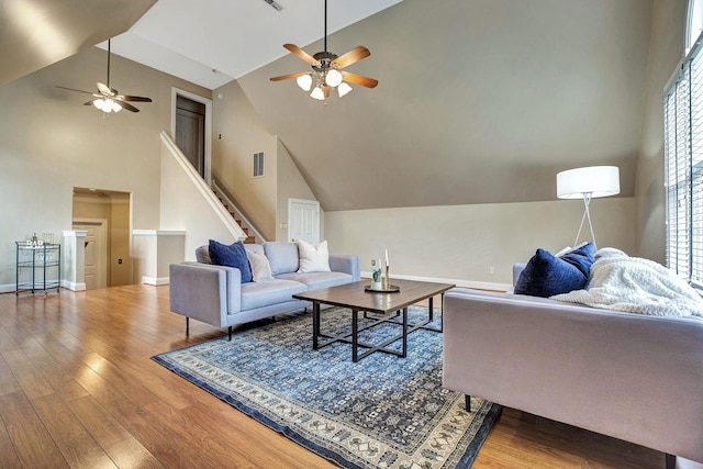 living room with visible vents, wood finished floors, and a wealth of natural light