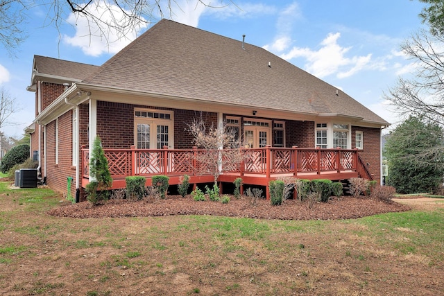 back of house featuring a yard, french doors, brick siding, and cooling unit