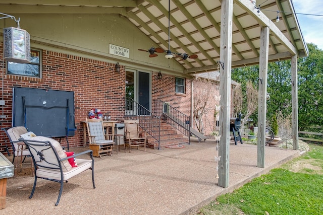 view of patio featuring entry steps and ceiling fan