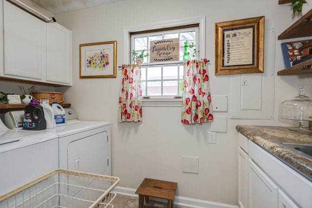 laundry area featuring washer and dryer, cabinet space, and baseboards