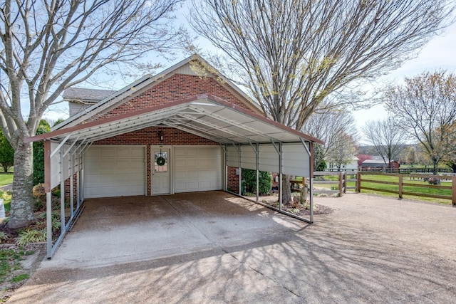 exterior space featuring a garage, a carport, and fence