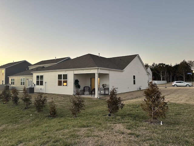 back of house featuring a yard, a patio area, and central air condition unit