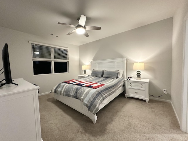 bedroom featuring a ceiling fan, light carpet, visible vents, and baseboards