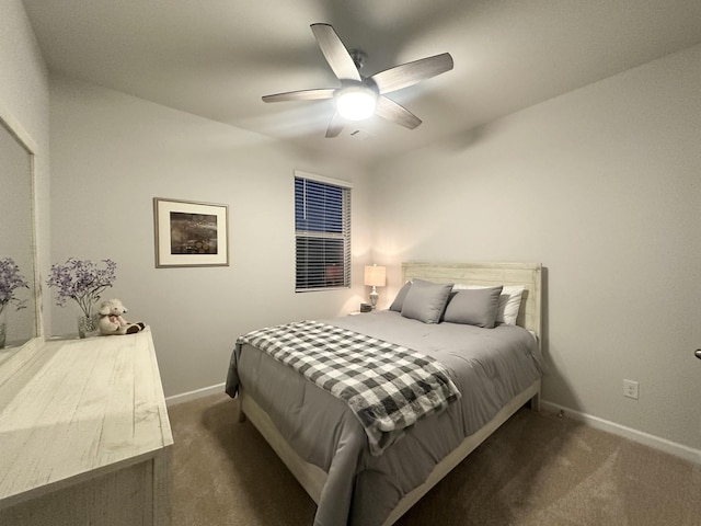 bedroom with a ceiling fan, dark carpet, and baseboards