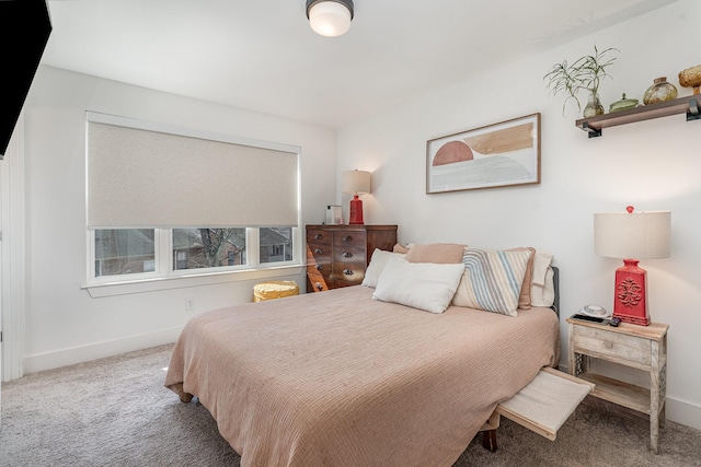 bedroom featuring carpet and baseboards