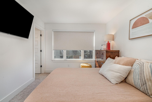 bedroom with carpet floors and baseboards