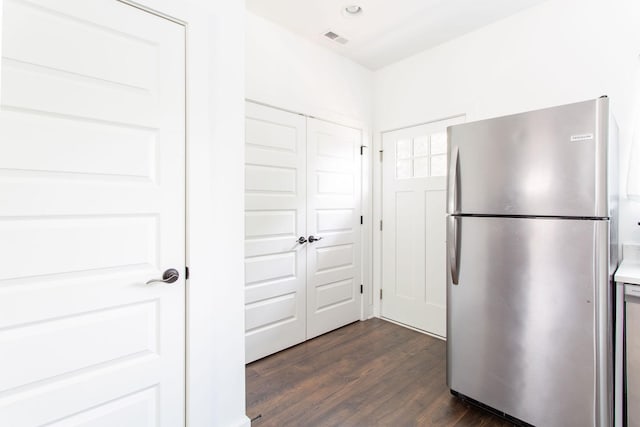 kitchen featuring visible vents, dark wood-style floors, freestanding refrigerator, light countertops, and recessed lighting