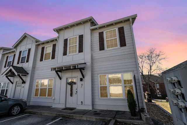 multi unit property featuring uncovered parking and board and batten siding