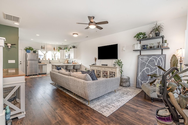 living room with dark wood-style flooring, recessed lighting, visible vents, and a ceiling fan