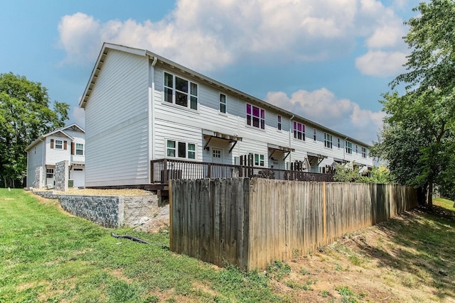 rear view of property featuring a yard