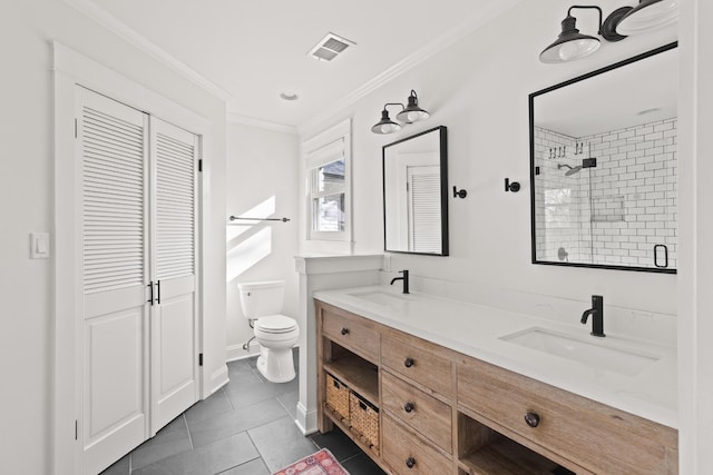 bathroom with a sink, crown molding, visible vents, and a closet