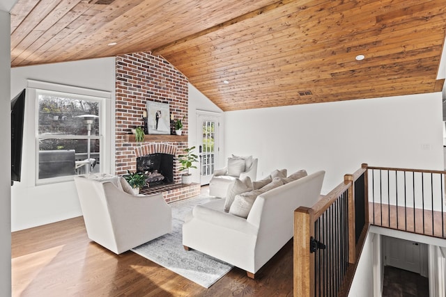 living area with wood ceiling, a fireplace, vaulted ceiling, and wood finished floors