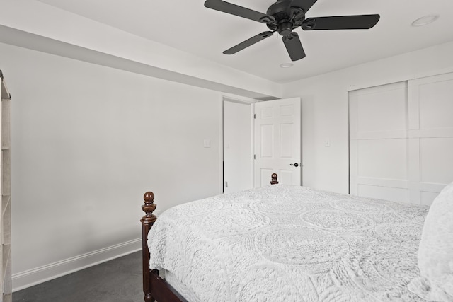 bedroom with a closet, ceiling fan, and baseboards