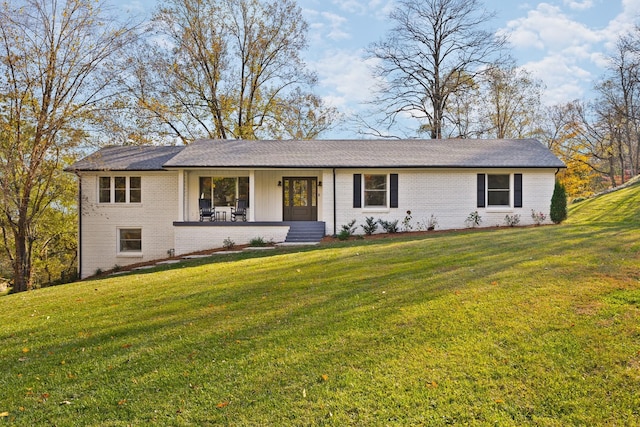 single story home featuring brick siding and a front yard