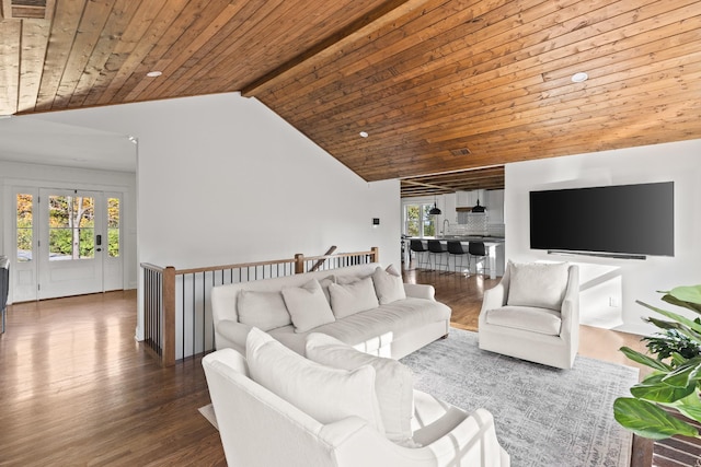 living area with lofted ceiling with beams, wooden ceiling, plenty of natural light, and wood finished floors