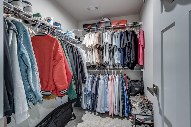 spacious closet featuring carpet flooring and visible vents