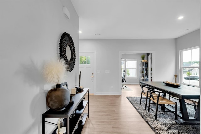 dining space featuring baseboards, light wood-style flooring, and recessed lighting