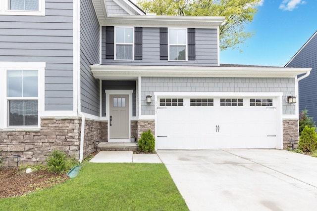 view of front of property featuring a garage, stone siding, and concrete driveway