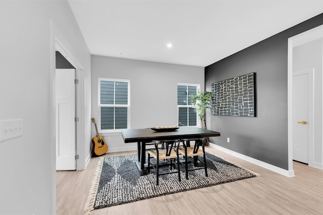 dining room with light wood-type flooring, baseboards, and recessed lighting