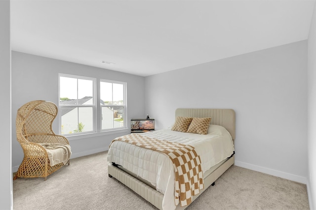 bedroom featuring visible vents, baseboards, and light colored carpet