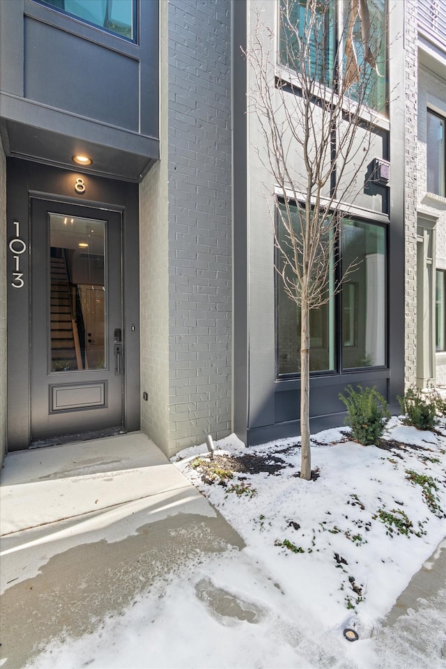 view of snow covered property entrance