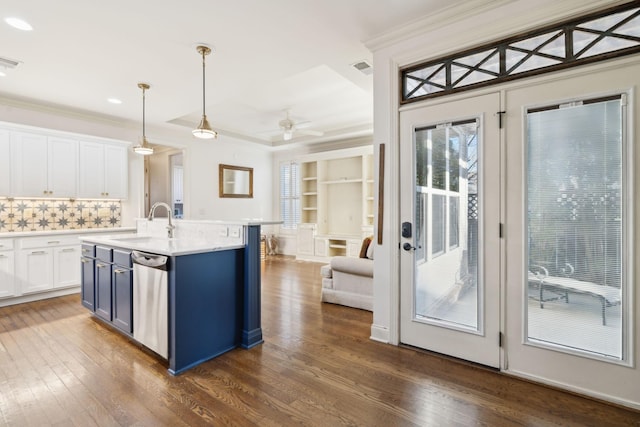 kitchen with stainless steel dishwasher, dark wood-type flooring, white cabinetry, a sink, and blue cabinets