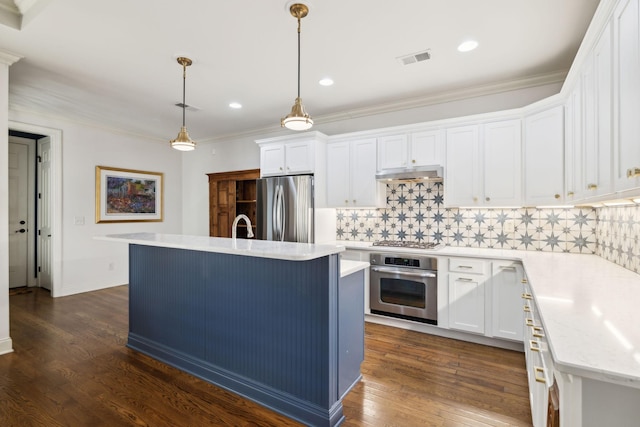 kitchen with visible vents, white cabinets, dark wood finished floors, stainless steel appliances, and under cabinet range hood