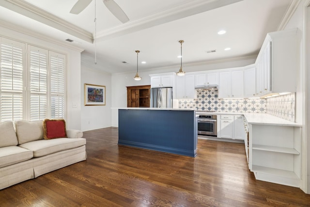 kitchen featuring a kitchen island, open floor plan, appliances with stainless steel finishes, dark wood-style floors, and tasteful backsplash