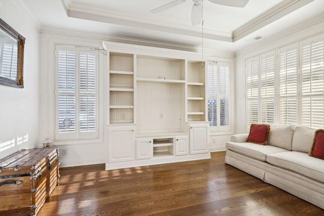 living room with dark wood-style floors, plenty of natural light, and a raised ceiling