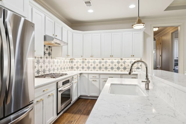 kitchen featuring stainless steel appliances, a sink, white cabinets, and under cabinet range hood