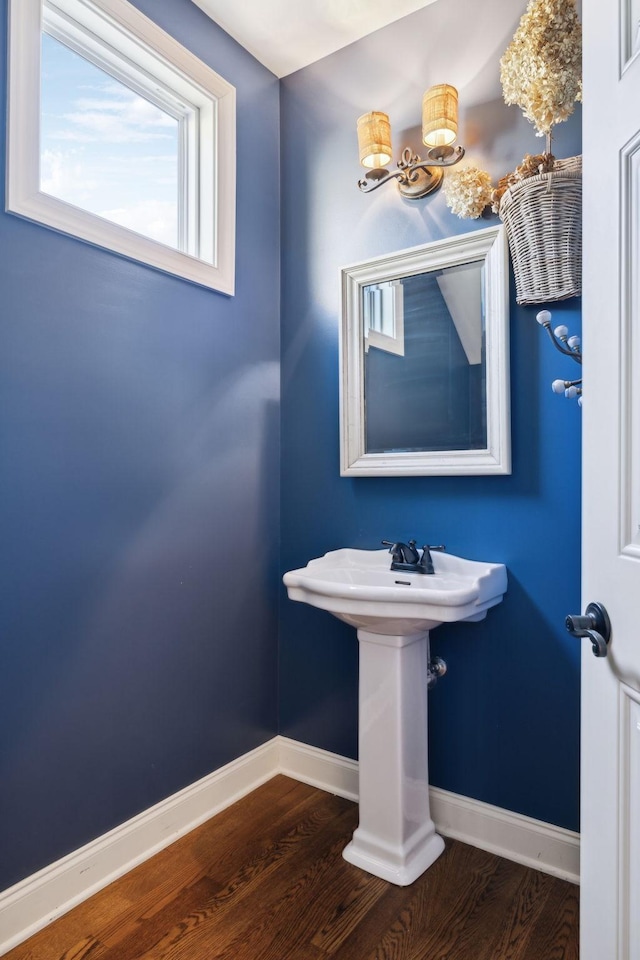 bathroom with baseboards and wood finished floors