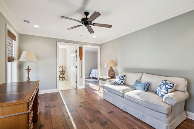 living area with dark wood-style flooring, visible vents, and baseboards