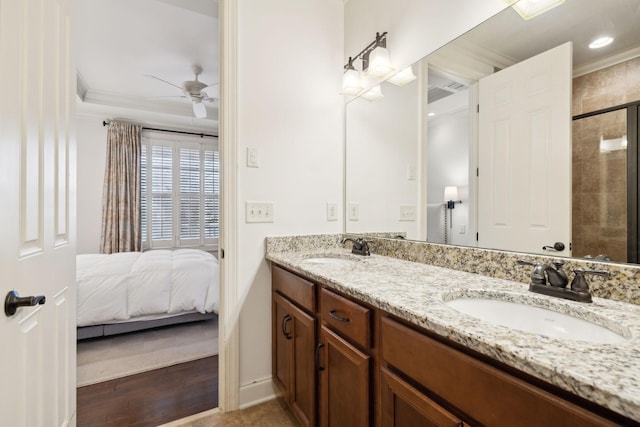 full bathroom with double vanity, crown molding, a ceiling fan, and a sink