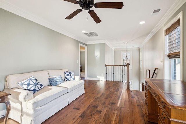 living room featuring visible vents, crown molding, and hardwood / wood-style flooring