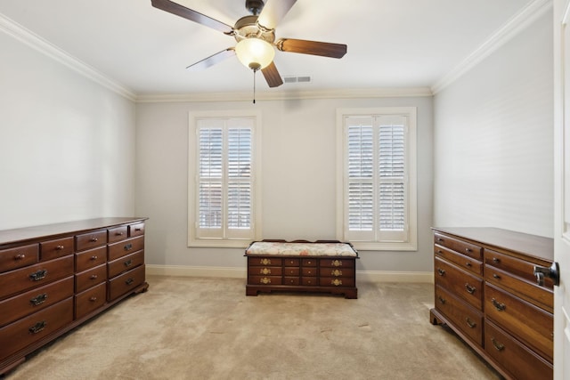 interior space with light carpet, a wealth of natural light, visible vents, and crown molding