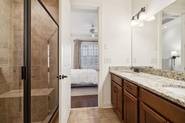 ensuite bathroom featuring a stall shower, a sink, ensuite bath, and double vanity