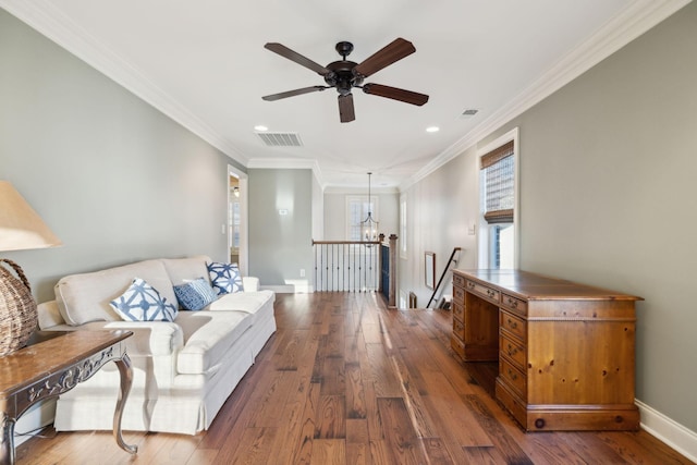 living area with baseboards, visible vents, and hardwood / wood-style floors