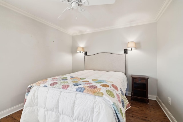 bedroom with crown molding, baseboards, and wood finished floors