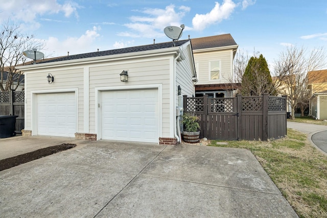 detached garage featuring fence