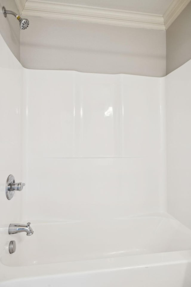 bathroom featuring  shower combination and crown molding