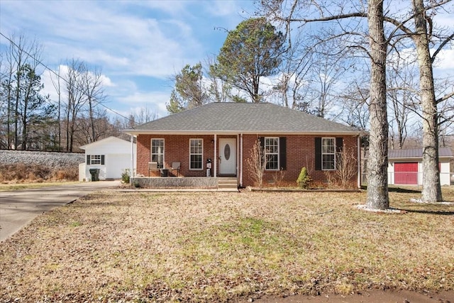 ranch-style home featuring a front lawn, a porch, and brick siding