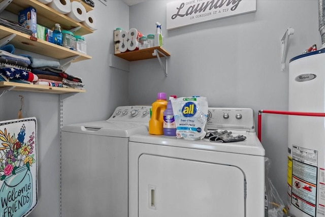 laundry area with gas water heater, washer and clothes dryer, and laundry area