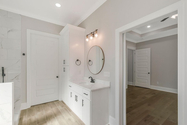 bathroom with recessed lighting, ornamental molding, vanity, wood finished floors, and walk in shower