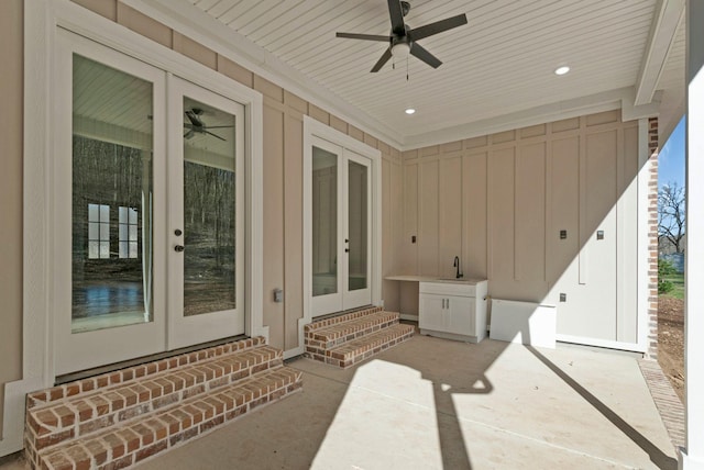 view of patio featuring entry steps, a ceiling fan, a sink, and french doors