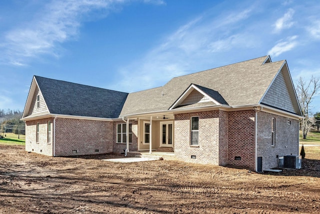 rear view of property with a patio area, crawl space, brick siding, and central AC unit